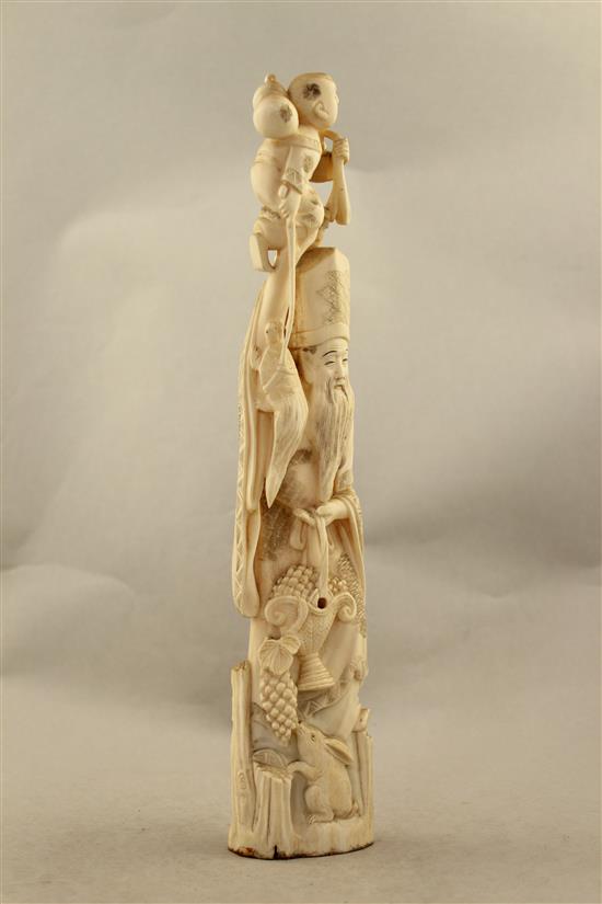 A Japanese walrus ivory tusk carving of Jurojin, early 20th century, 33.5cm